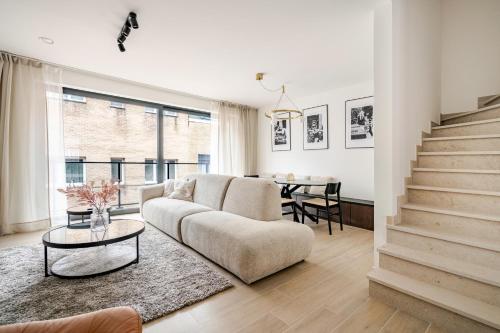 a living room with a couch and a table at Casa Blanc - Coastal Triplex in Blankenberge