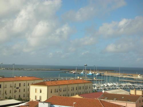 a view of a harbor with boats in the water at Petronia Home in Porto Torres