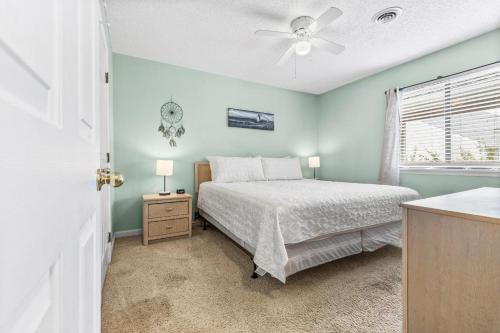 a bedroom with a bed and a ceiling fan at Baytree 28G in Little River