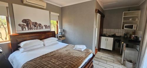 a bedroom with a large bed with white pillows at Acacia at Greenway Woods in White River