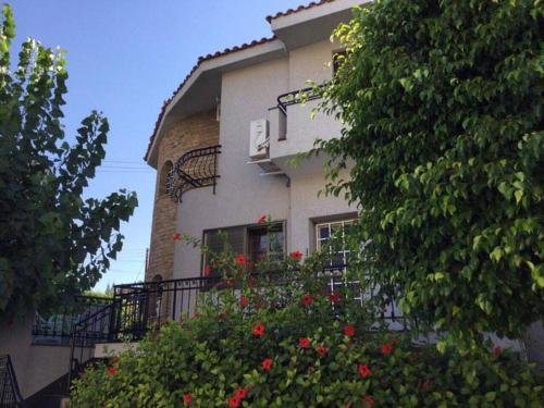 a building with red flowers in front of it at Nikola's House in Limassol