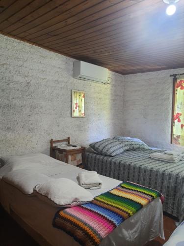 a room with two beds in a room at Sítio do Berger 1 in São Gabriel