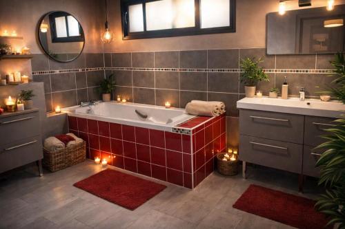a bathroom with a tub and two sinks and candles at le Sunset Loft 88 maison neuve et moderne in Sainte-Adresse