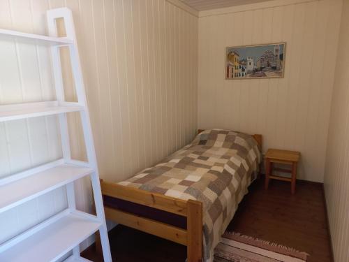 a small bedroom with a bed and a ladder at Lohusalu Studio in Lohusalu