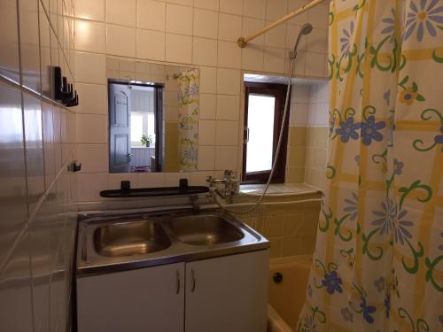 a bathroom with a sink and a shower curtain at Lohusalu Studio in Lohusalu