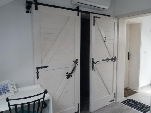 a sliding barn door in a room with a desk at Rooms GRIZZLY in Slunj