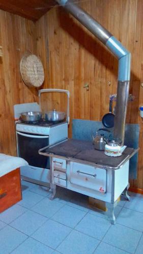 a kitchen with a stove and some pots and pans at Casa Sureña en Ensenada in La Ensenada