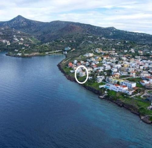 a large white object on an island in the water at Almyra seaside in Perdika