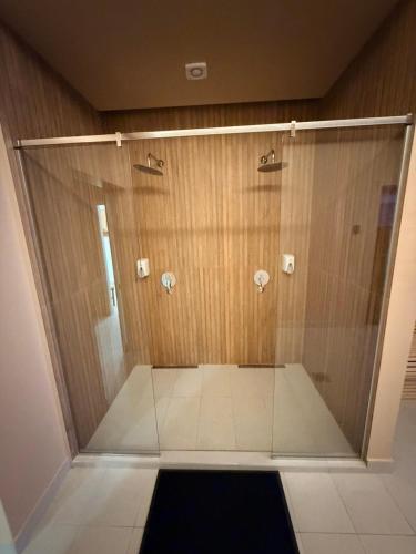 a shower with a glass door in a bathroom at Apartman Skyline Kopaonik in Kopaonik