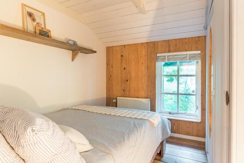 a bedroom with a bed and a window at farmhouse in Wijdewormer