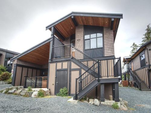 a house with a staircase in front of it at Oceanfront Marina & Mountain views- pet friendly in Port Renfrew