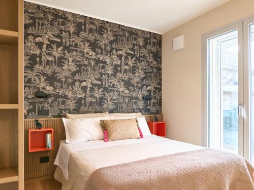 a bedroom with a large bed with a black and white wallpaper at A la plage R in San Benedetto del Tronto