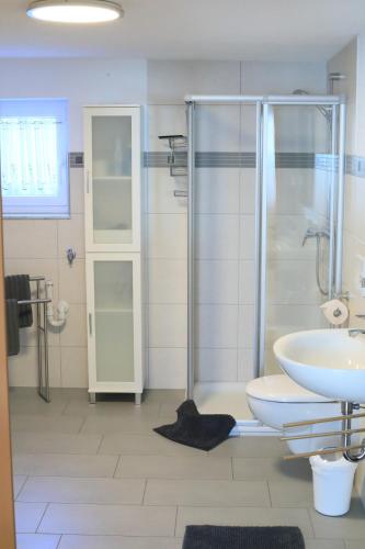 a bathroom with a shower and a toilet and a sink at Albglück in Gammertingen