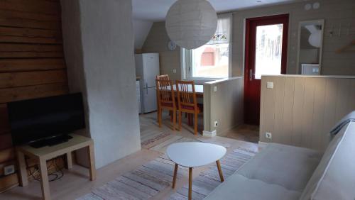a living room with a couch and a table and a tv at Lohusalu Apartment in Lohusalu