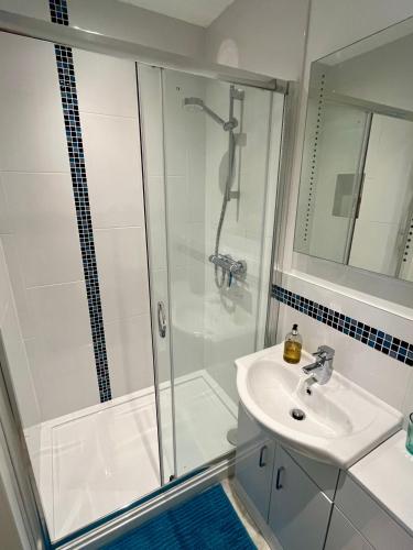 a bathroom with a shower and a sink at Acorns in Hordle