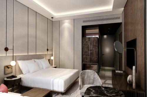 a hotel room with a bed and a chair at Kampala Marriott Hotel in Kampala
