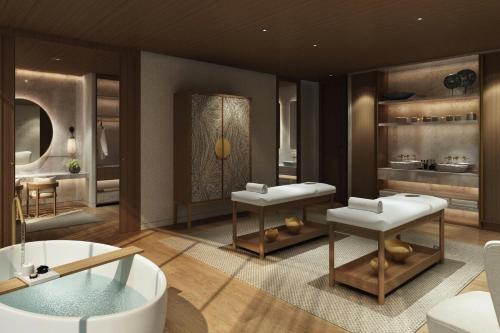 a bathroom with two sinks and a bath tub at Kampala Marriott Hotel in Kampala