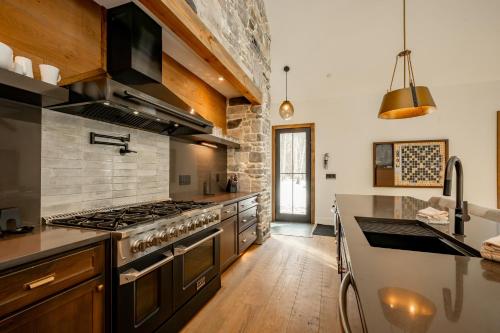 a large kitchen with a stove and a counter at Deep Creek Modern by Railey Vacations in Oakland