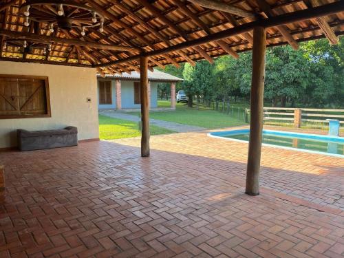 an outdoor patio with a pavilion and a pool at Recanto do Sossego in Gravataí