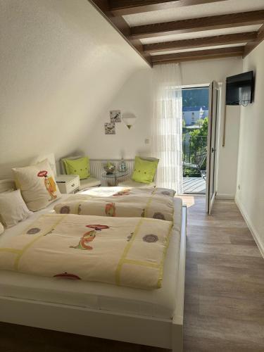 a bedroom with two beds and a balcony at Haus Marientaler Au GbR in Zell an der Mosel