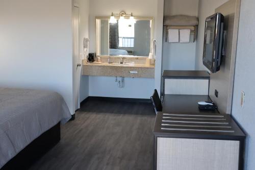 a hotel room with a bed and a sink at legacy inn paducah in Paducah