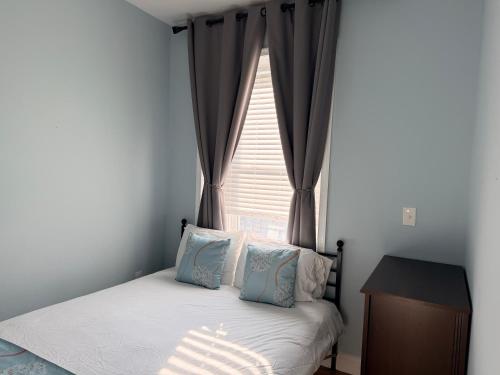 a small bedroom with a bed and a window at Fresh&Quiet One Bedroom Apartment in University City Walk to Drexel&Near UPenn in Philadelphia