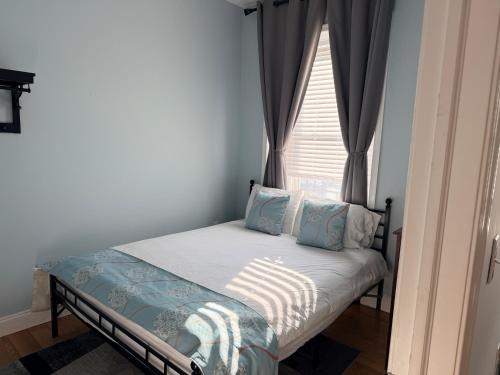 a small bed in a room with a window at Fresh&Quiet One Bedroom Apartment in University City Walk to Drexel&Near UPenn in Philadelphia