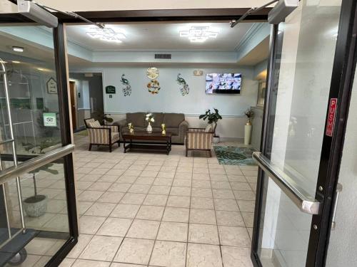 a living room with a couch and a table at Wesley Inn and Suites in Wichita