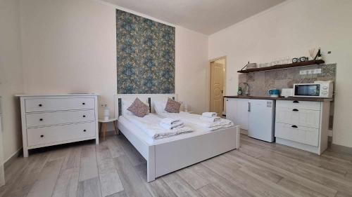 a living room with a bed and a kitchen at River Apartment in Makó