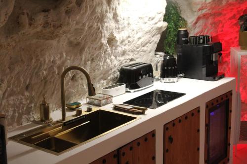 a kitchen with a sink and a counter top at L alcove des Sens Love Room Jacuzzi sauna in Tours