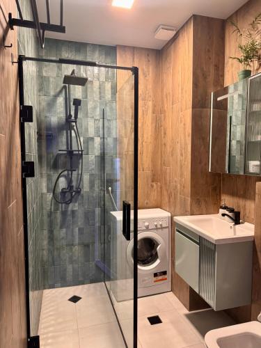 a bathroom with a washing machine and a sink at Seafront Gonio Studio in Gonio