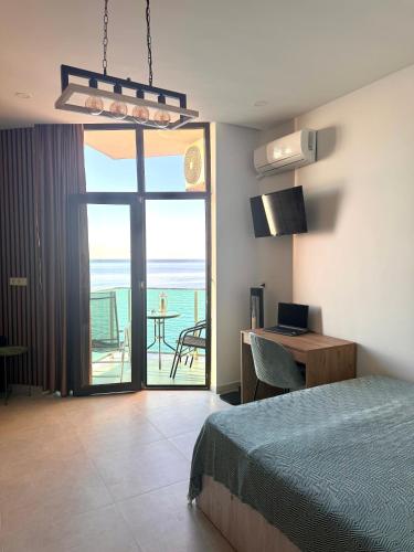 a bedroom with a bed and a view of the ocean at Seafront Gonio Studio in Gonio