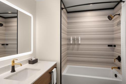 a bathroom with a sink and a shower at Hampton Inn By Hilton Calgary Downtown in Calgary