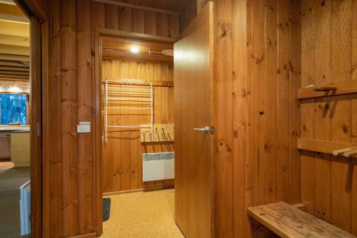 a room with wooden walls and a room with a door at Sun Apartments in Mount Hotham
