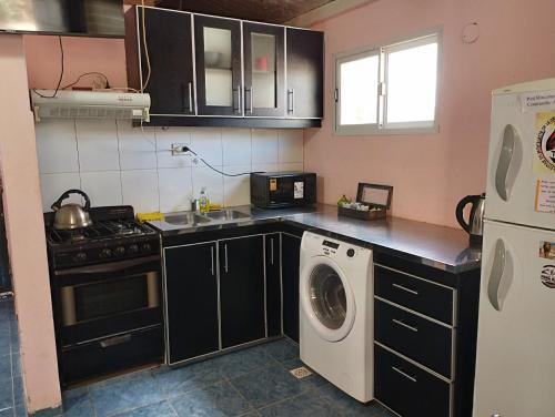 a kitchen with a washing machine and a washer at Rincones de la Puna in Antofagasta de la Sierra