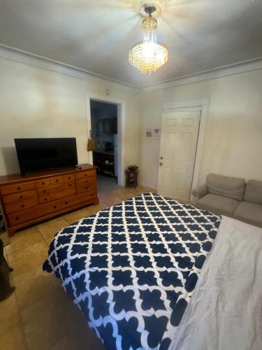 a bedroom with a bed and a flat screen tv at *PRIVATE* Studio 5 minutes from LGA/ US Open in East Elmhurst