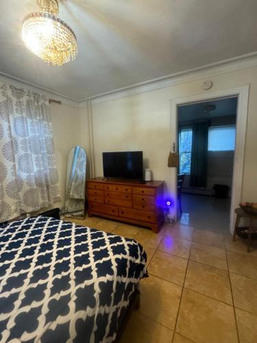 a bedroom with a bed and a television on a dresser at *PRIVATE* Studio 5 minutes from LGA/ US Open in East Elmhurst