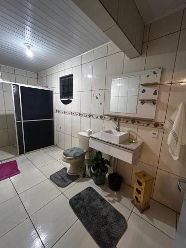a bathroom with a sink and a toilet at Pousada da Drika in São Gabriel