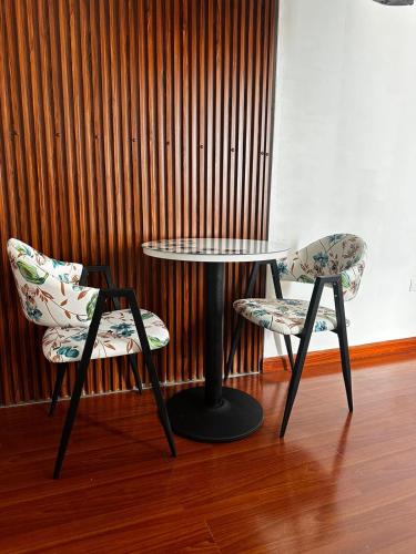 two chairs and a table and a table and two chairs at Éclat Hotel Boutique in Iquique
