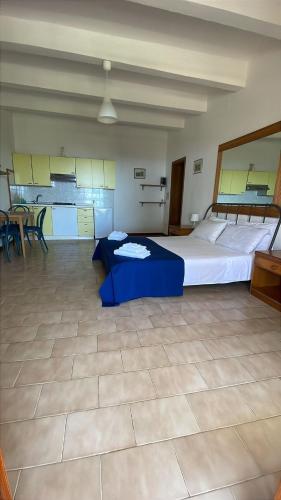 a large room with a large bed and a kitchen at Villa Conti Residence in Lacona
