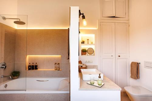 a bathroom with a shower and a sink and a toilet at Veles Dos, villa con piscina frente al mar in Alcudia