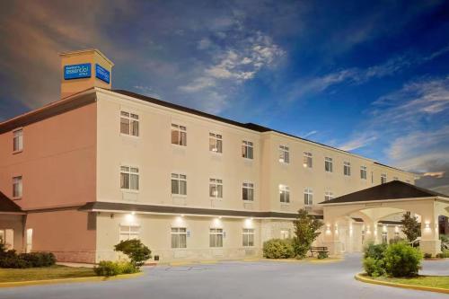 a large white building with a clock tower on top at Sonesta Essential Hotels Odessa in Odessa