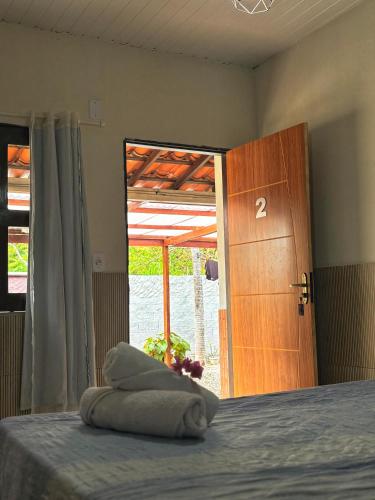 a bedroom with a bed and a door with a number two at Espaço Augusto in Barreirinhas