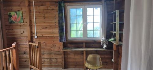 a wooden room with a window and a chair at Duplex escape in Quartier Palmène
