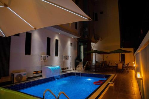 a large swimming pool in a building with at Nirvana City Hotel in Benin City