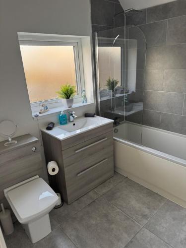 a bathroom with a sink and a toilet and a shower at Rowe Terrace Workington in Workington