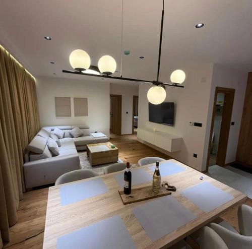 a living room with a couch and a table at Prestige Lux Andan - Apart hotel Horizont Jahorina in Jahorina