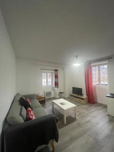 a living room with a couch and a table at Compostelle Chemin Garazi in Uhart-Cize