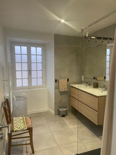 a bathroom with a sink and a glass shower at Compostelle Chemin Garazi in Uhart-Cize
