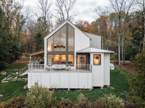 a house on a hill with a lot of glass at Wild Pond Villa in Mansonville